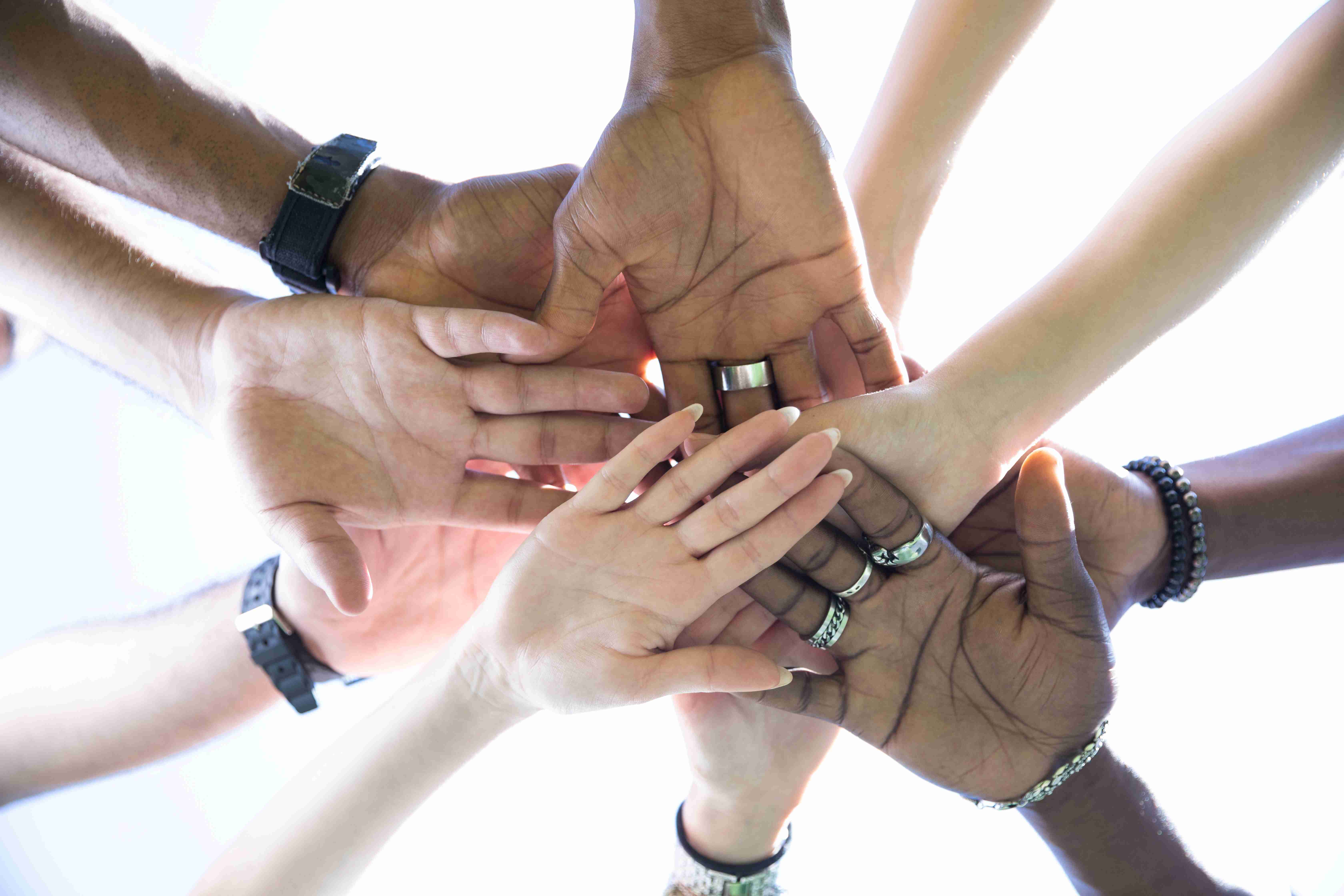 bottom-view-people-putting-hands-together