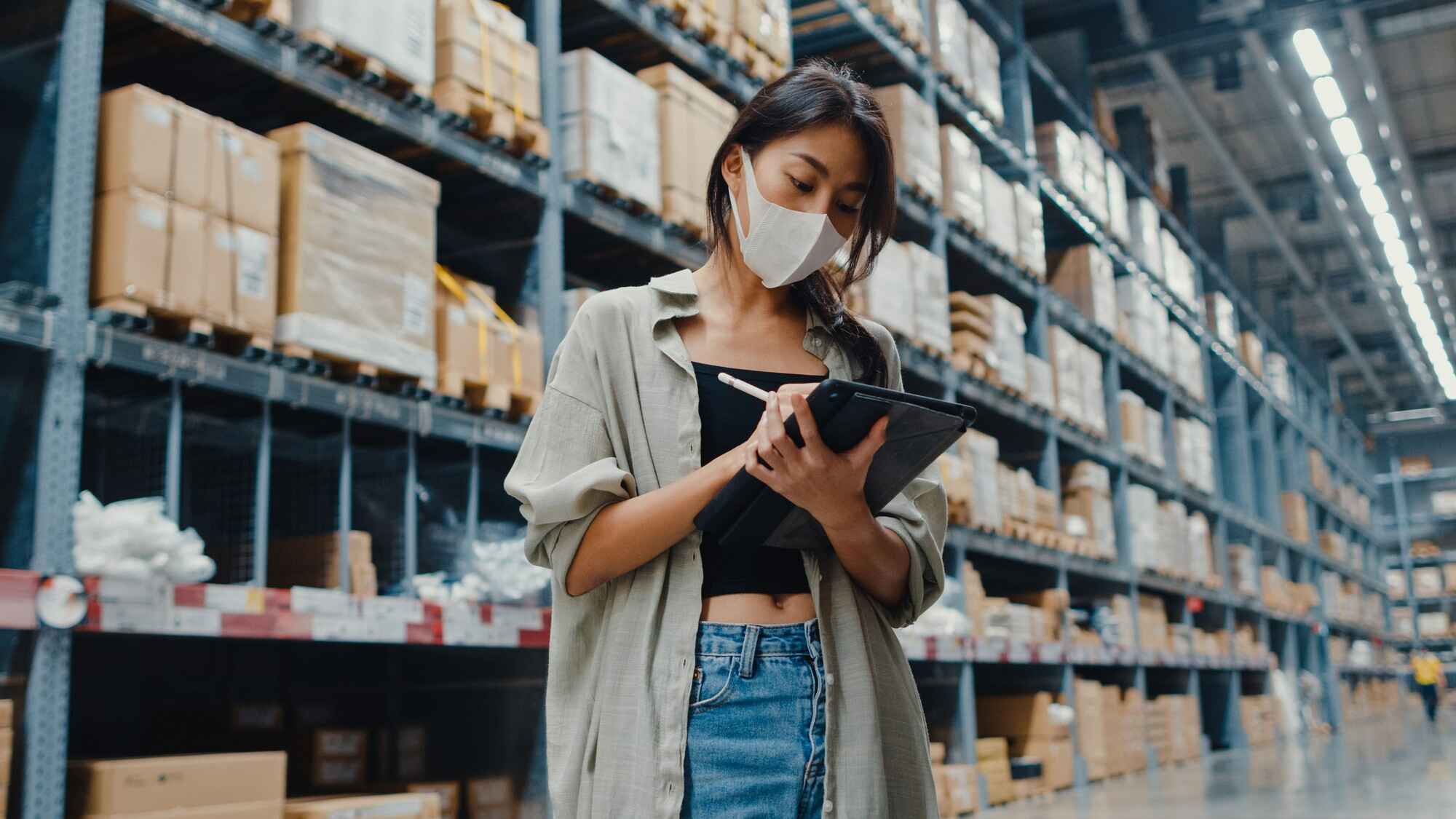 Young asian businesswoman manager warehouse checking inventory