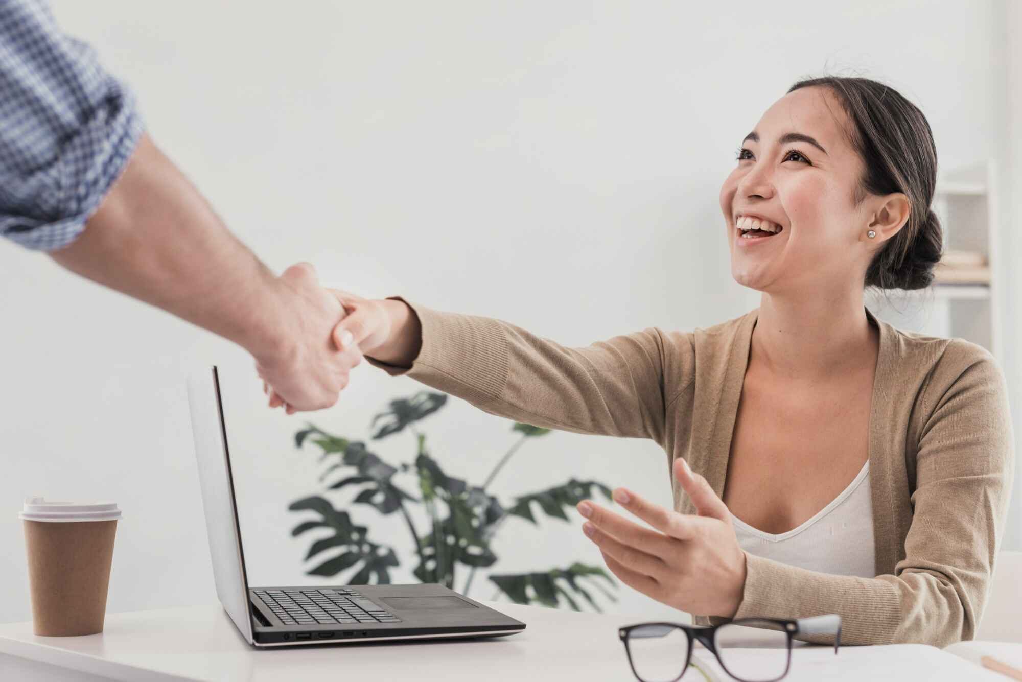 Handshake at office with happy customer.