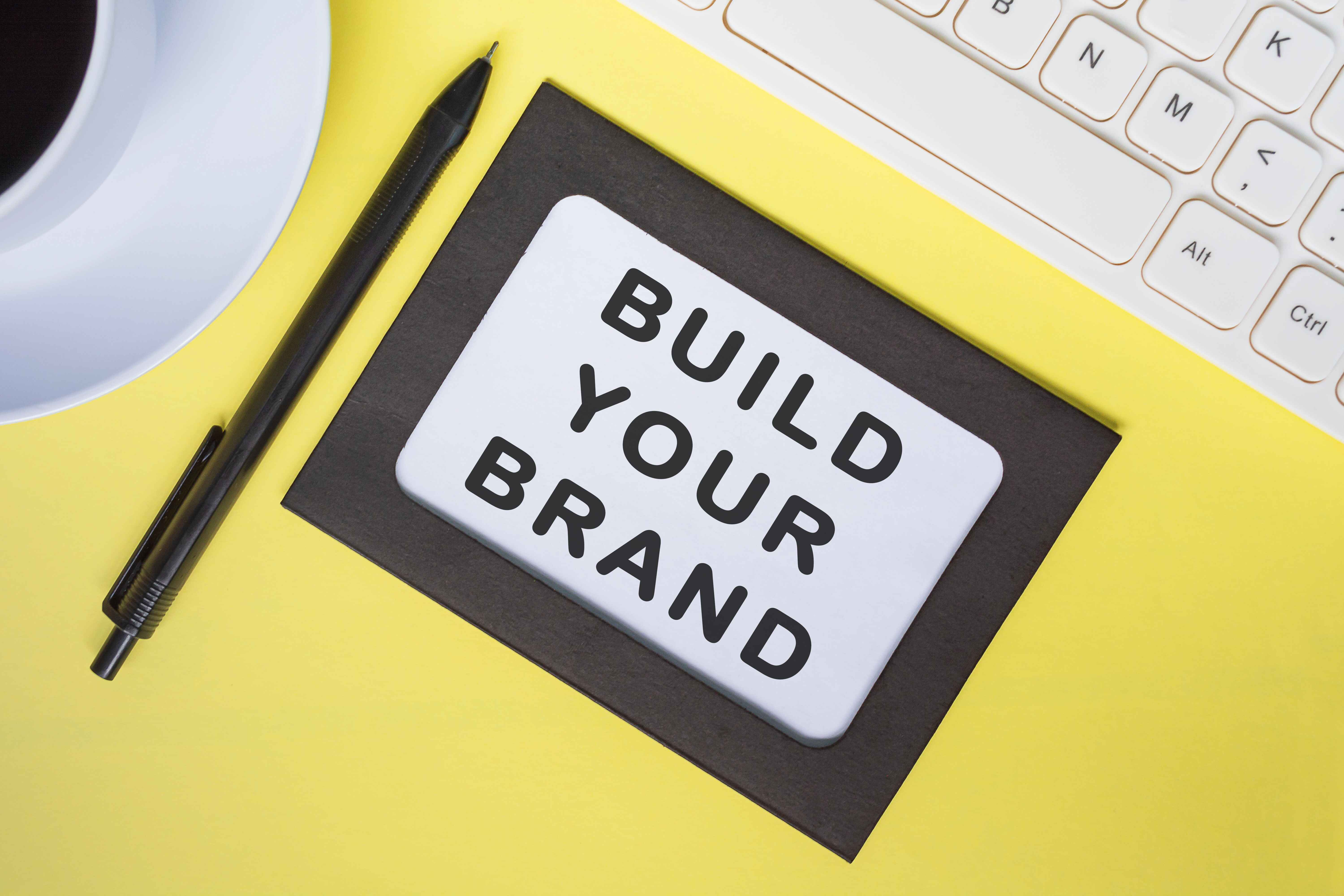 build-your-brand-text-on-white-note-with-yellow-sheet-on