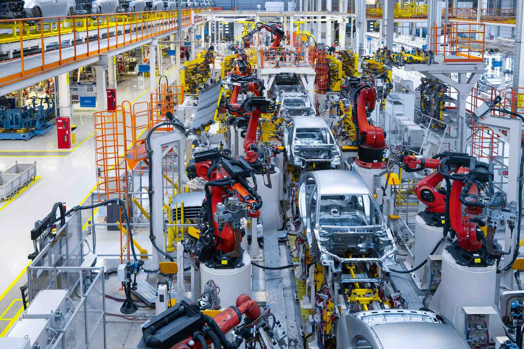 Assembly line production of new car. Automated welding of car body on production line.