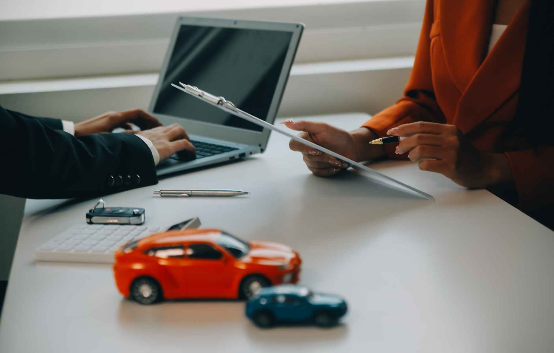 Asian male to sell a car and explains and reads the terms of signing a car contract and insurance