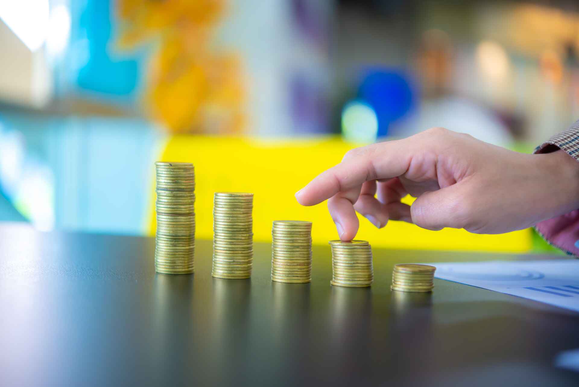 Business women touching pile of coins. Boost sales and profit.